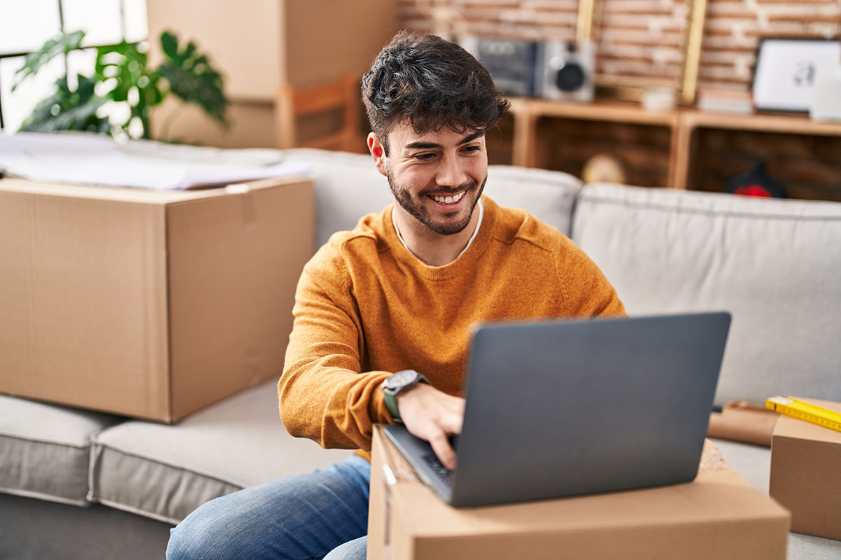 man using laptop in new house